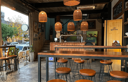 Wine Bar With Arched Windows and Colourful Wall Art for Mixers