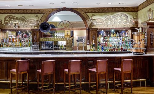 Elegant Coffee Space with Central Bar and Timeless Architectural Charm