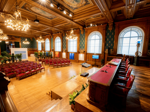 Neoclassical Wood-Paneled Conference Hall With Stage for Corporate Events