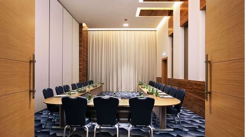 Refined Event Space With Wooden Panels and Bold Flooring for High-Level Meetings