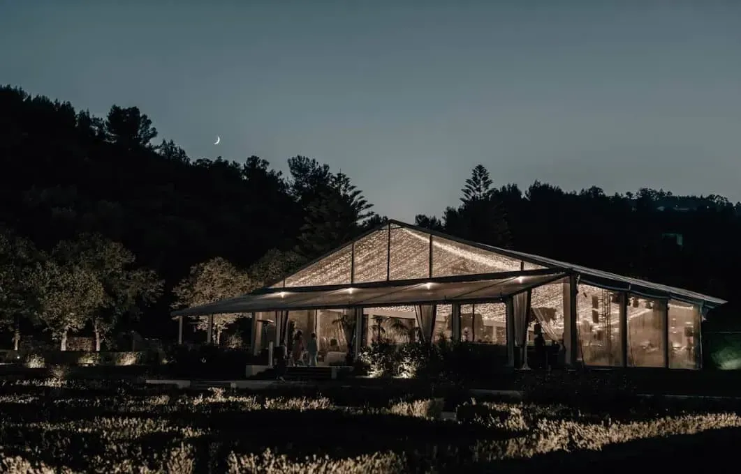 A Green Event Location in Lisbon in a Tent Overlooking Boxwood Gardens.webp