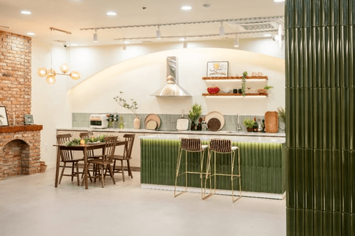 Contemporary Mediterranean Lounge With Fluted Island and Brick Fireplace for Casual Networking Dinners