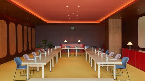 Trendy Meeting Room With High Ceilings and Ample Space