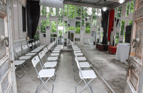 Rustic Venue Surrounded by Vibrant Greenery