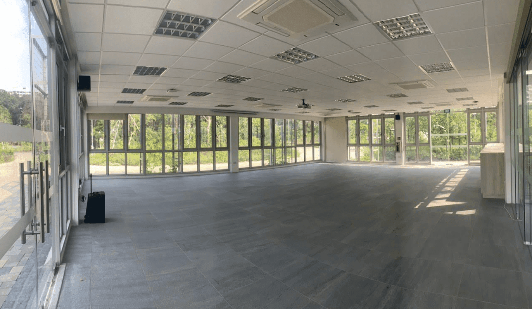A glass-enclosed function hall with inspiring garden views.png