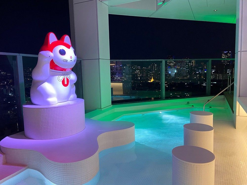 A sleek lounge rental in Tokyo with an illuminated pool and skyline views.jpg