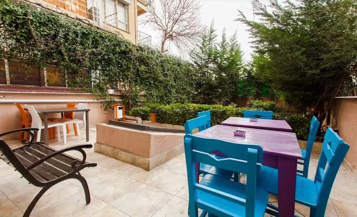 Rent a party venue on a charming terrace with bright portico furniture.webp