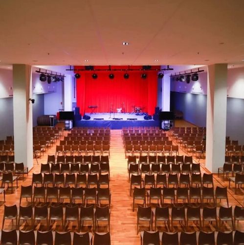 Expansive Classical Auditorium With Velvet Stage for Formal Ceremonies