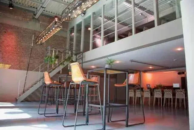 A dynamic event space in Amsterdam with a double-height brick wall.webp