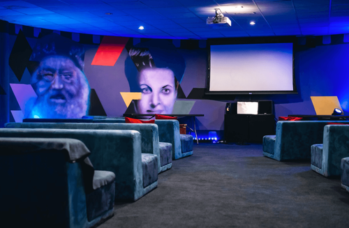 Innovative Event Venue With Large Screen and Comfy Seating