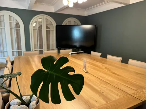Sophisticated Blue-Walled Boardroom with Large Windows for Conferences