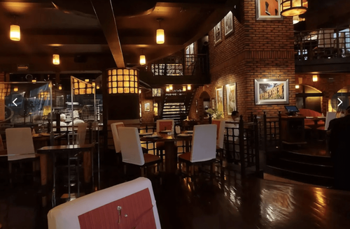 Amber-Lit Brick-Walled Banquet Hall for Elegant Networking