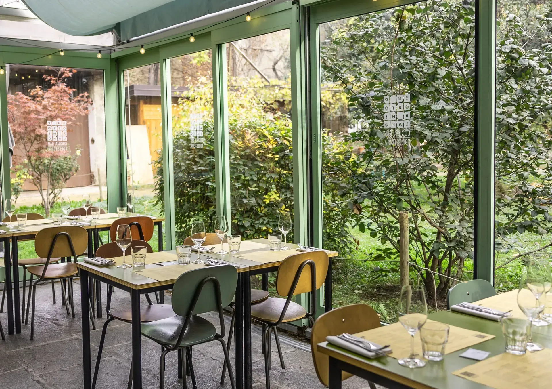 A small party venue in a sunlit verandah with teal accents and garden views.webp