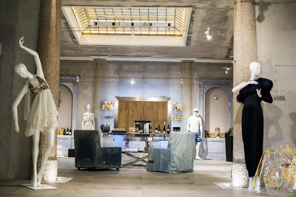 An unusual event venue in a skylit industrial space with raw concrete aesthetics.jpg
