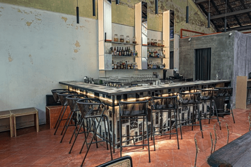 Mosaic-Bar Hideout With Rustic Concrete Charm and Outdoor Patio for Laid-Back Celebrations