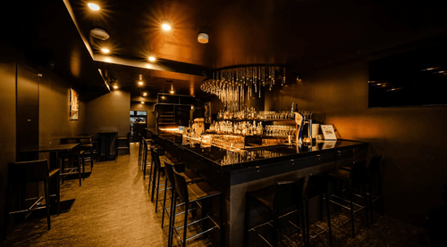 Moody Black Bar With Luxe Lighting and Lush Terrace for Sophisticated Soirées