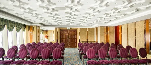 Elegant Ballroom With Gold Accents and Plush Carpeting for Engaging Events