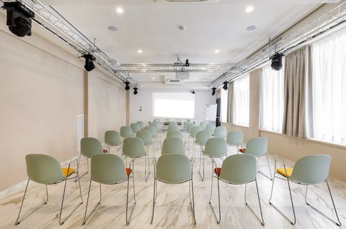 Soft-Toned Classroom With Glossy Marble Tiling and Pastel Chairs