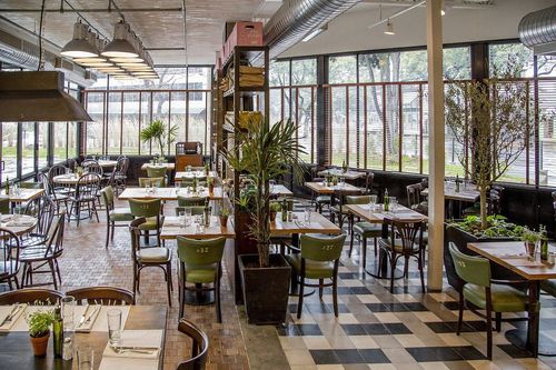Bright Industrial-Style Setting With Greenery and Flexible Table Arrangements