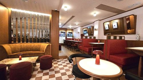 Retro-Chic Resto-Bar With Plush Booths and Built-In Bar for Corporate Dinners