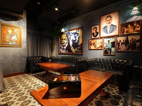 Elegant Vintage Lounge With Leather Seating & Portraits for Private Tastings and Gatherings