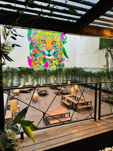 Rustic Terrace With Greenery and Vibrant Leopard Mural for Cocktails
