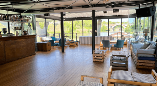 Charming Rooftop Terrace With Glass Railings and Wooden Flooring for Networking Soirées