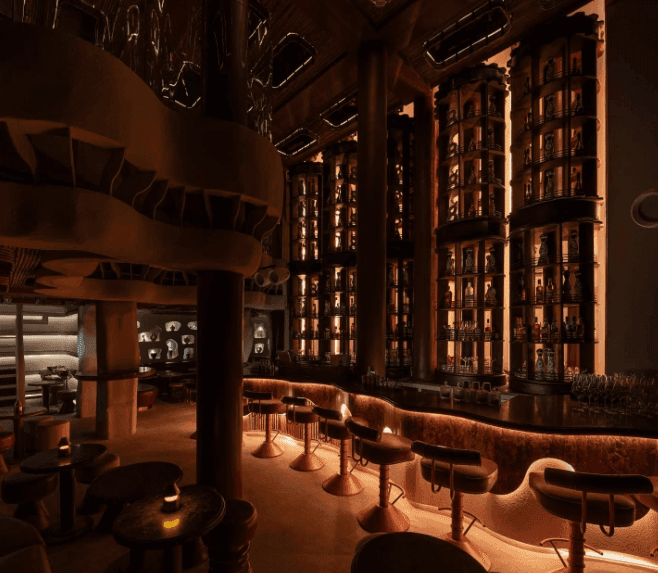 A curvilinear lounge with dramatic lighting in Bangkok designed for engaging the five senses.png