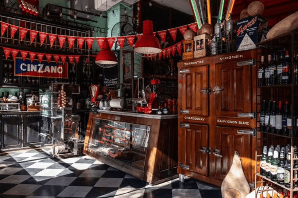 A lively vintage networking bar in Buenos Aires with football decor.png