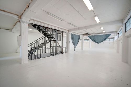 Minimalist White Gallery With Industrial Charm for Artistic Showcases