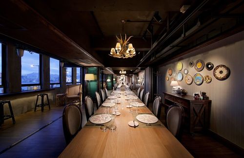 Timber-Beamed Dining Room With Antique Decor and City Vistas for Intimate and Private Gatherings