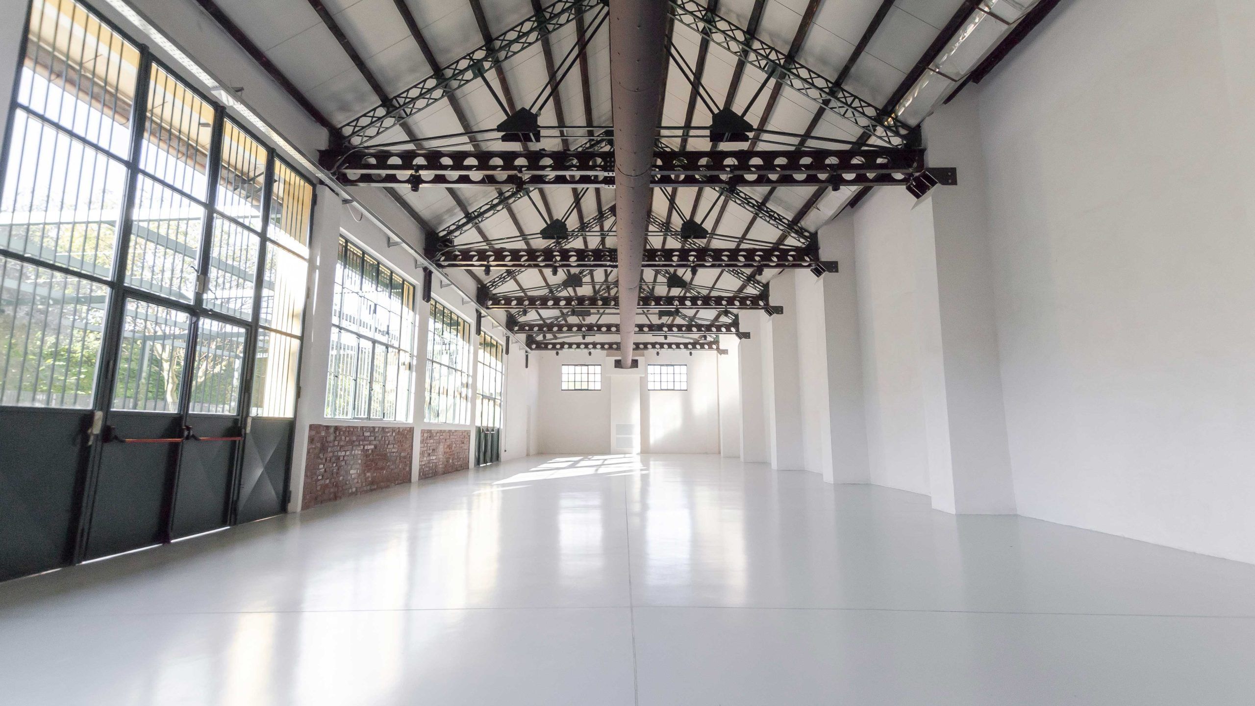 An industrial event warehouse with large windows and a courtyard.jpg