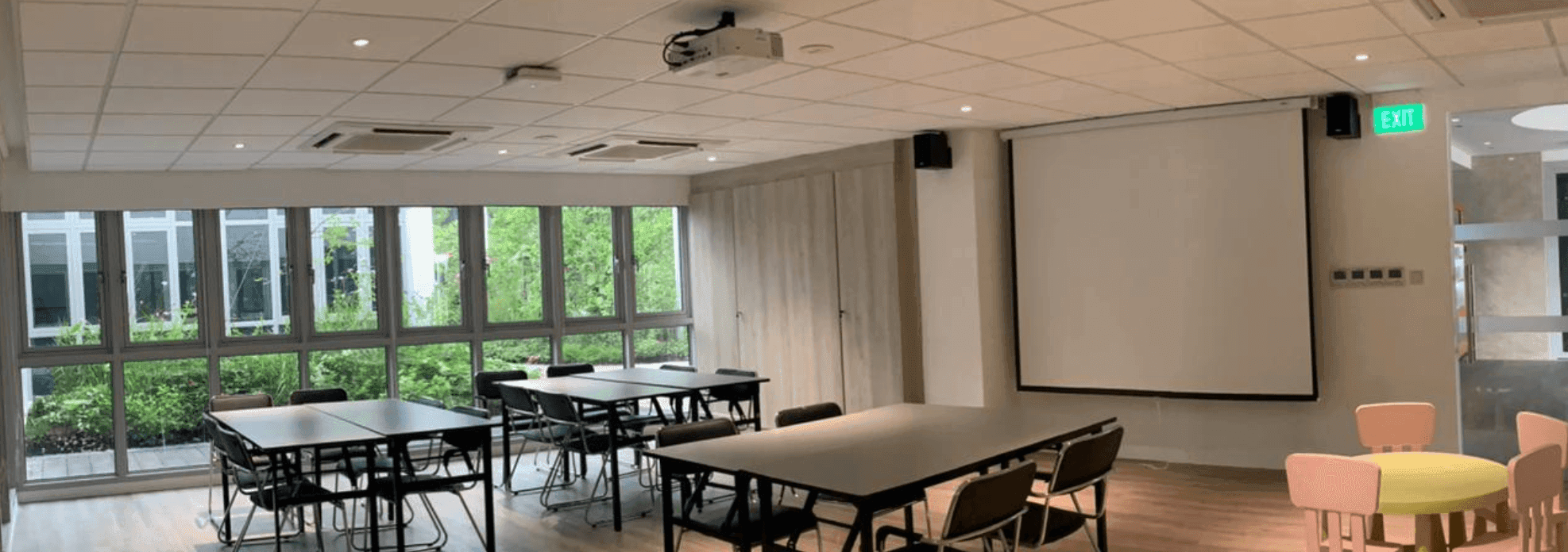 A contemporary brainstorming room with a garden view in Singapore.png