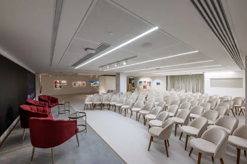 Elegant White Modern Venue With Plush Seating for Stylish Brand Launches
