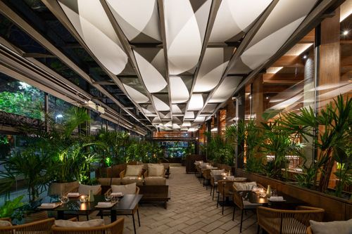 Open-Air Terrace Framed by Contemporary Wooden Details and Lush Greenery