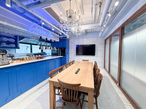 Blue-Toned Chef’s Table Boardoom With Classic Chandelier for Collaborative Workshops