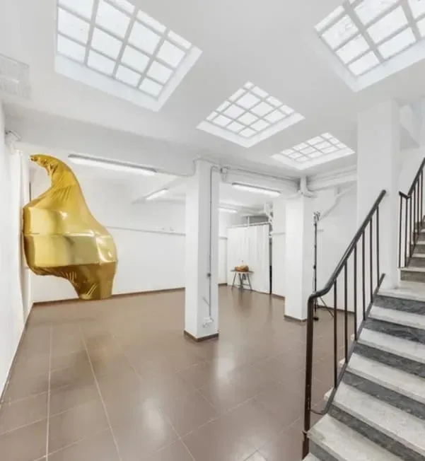 A bright and minimalist artist studio space for rent with skylights.webp