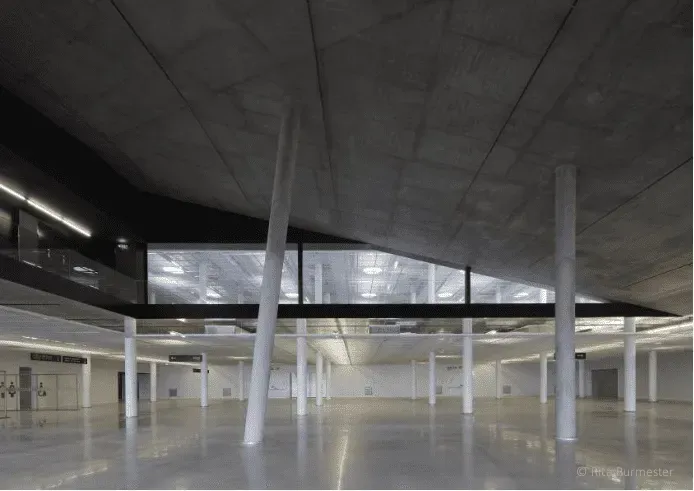 A sleek industrial exhibition rental with a coastal view.webp