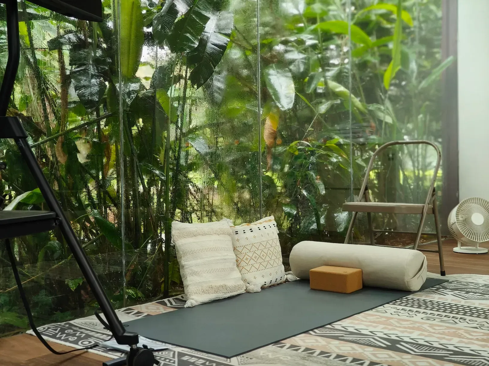 A top hidden rustic meeting venue in a glass-walled sanctuary with lush greenery.webp