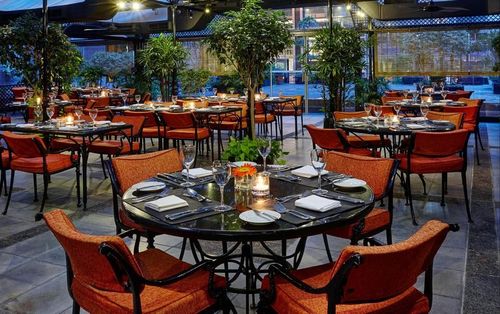 Bright Terrace with Lush Greenery and Industrial Design for Corporate Gatherings