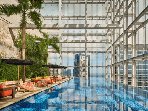 Luxe Rooftop Sky Pool Deck With Palm Groves and Expansive Glass Façades for High-End Evening Receptions
