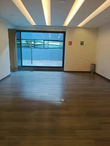 Streamlined Room With Terrace Access and Sleek Wood Floors for Workshops