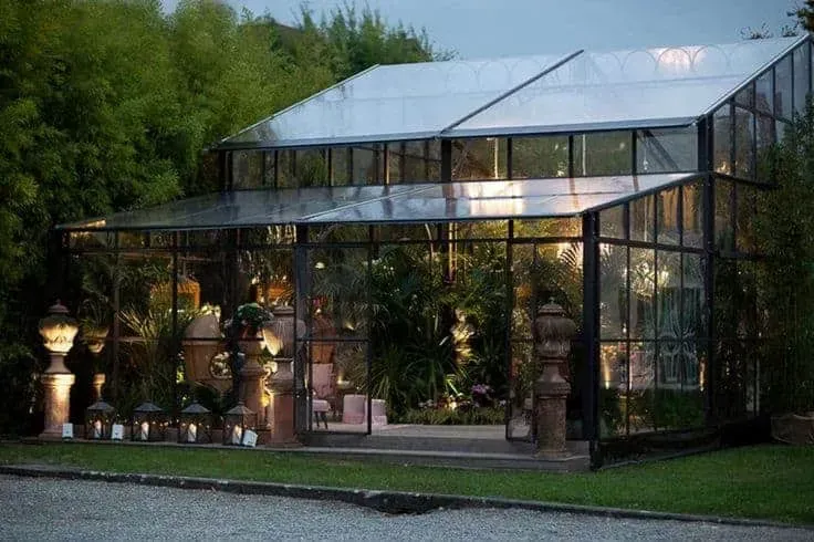 Stunning Glasshouse Haven in Milan Surrounded By Lush Greenery.webp