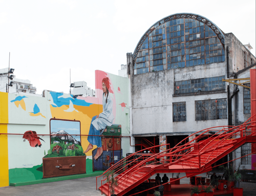 Industrial Warehouse Courtyard With Colourful Murals & Red Sculptural Staircase for Large-Scale Events