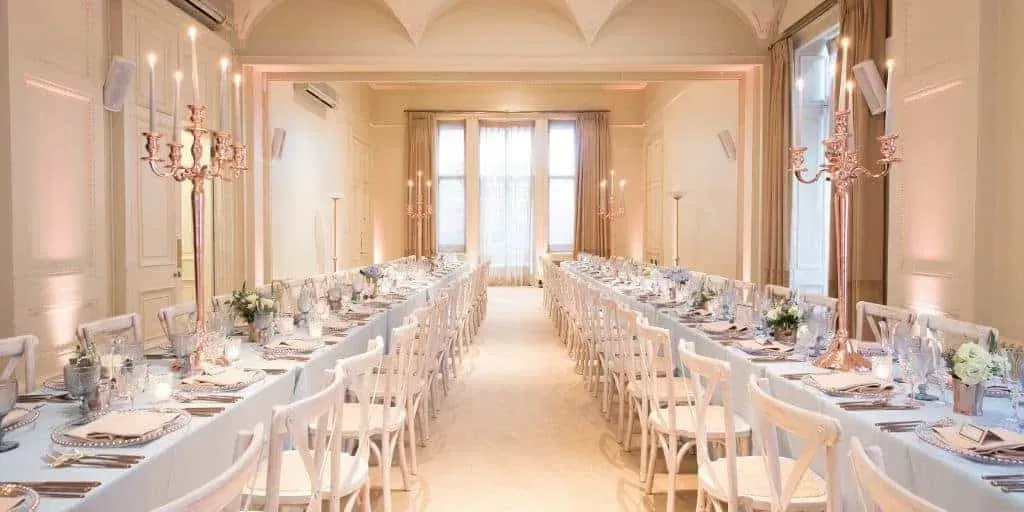 Elegant Victorian venue in London with period ceilings and a vintage fireplace.webp