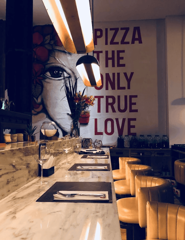 A sleek Italian pizzeria with a chic atmosphere for corporate drinks in Buenos Aires.png