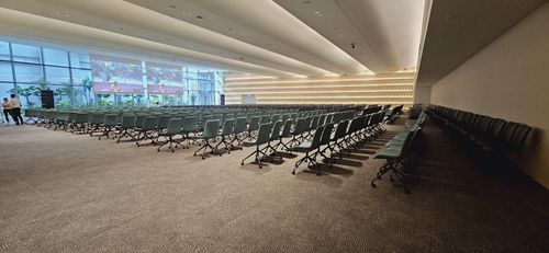 Spacious Modern Hall With Expansive Glass Walls and Sunlit Ambience for Corporate Seminars and Forums