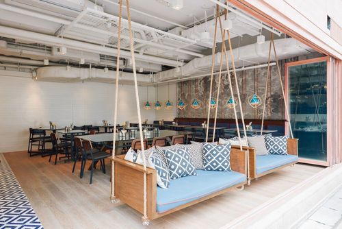 Playful Eatery With Suspended Swing Benches and Open Space for Laid-Back and Unwind Gatherings