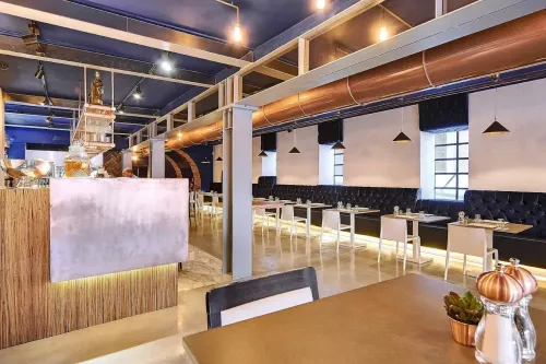 Industrial Gastro Bar With Velvet Seating and Terrace Access for Corporate Mixers