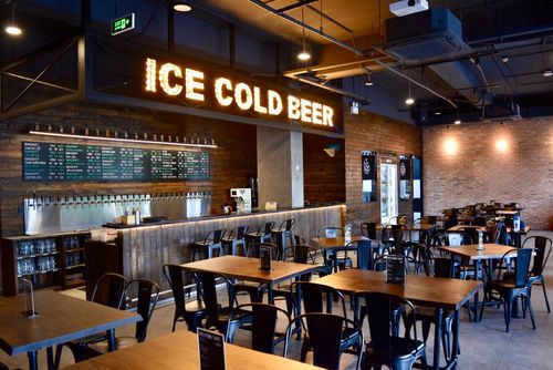 Urban Industrial Pub With Exposed Brick and Warm Wooden Accents for Team Gatherings